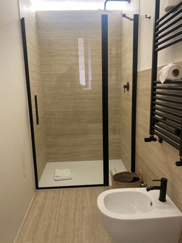 a bathroom with a glass shower and a sink at Veneto Suite 2 by SupaStays - King room in Rome