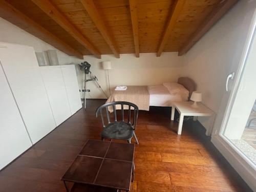 a room with a bed and a table and a chair at La Bella Ossuccio in Ossuccio