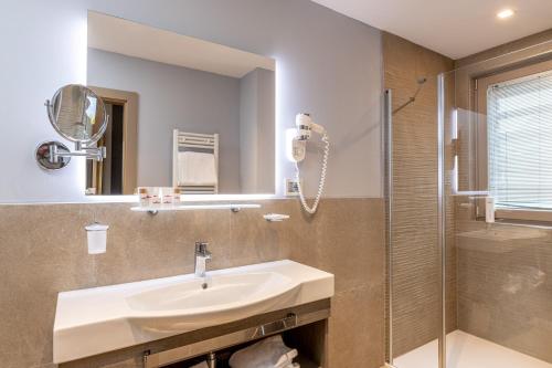 a bathroom with a sink and a shower at Hotel Villa Madruzzo in Trento