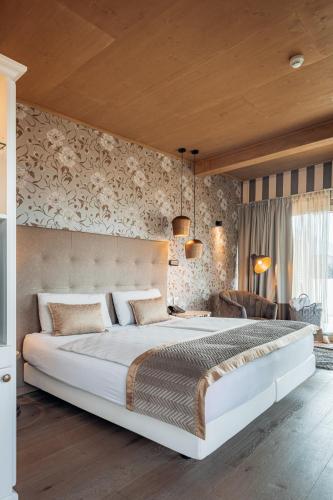 a bedroom with a large white bed in a room at Hotel Villa Madruzzo in Trento