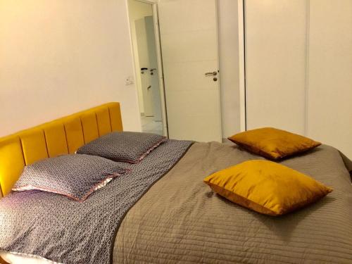 une chambre avec un lit avec deux oreillers dessus dans l'établissement APPARTEMENT T2 VELODROME PRADO, à Marseille