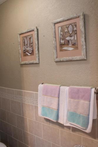 a bathroom with three towels hanging on a wall at Charming Retreat in heart of Amarillo in Amarillo