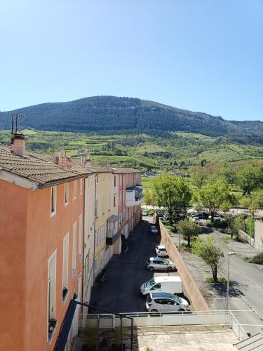 a view of a street with cars parked in a parking lot at Cosy Studio - Heart of Millau in Millau