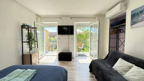 - une chambre avec un lit et une télévision dans l'établissement Charmant T1 entre ville et lac avec balcon, à Aix-les-Bains