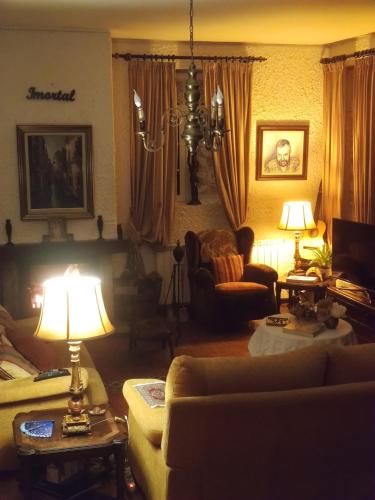 a living room with a couch and a table with a lamp at Real Santo António Guest House in Tarouca