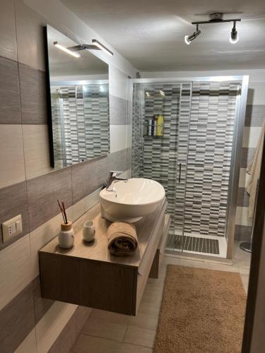 a bathroom with a white sink and a shower at Casa Vacanze Manzoni 29 in Cagliari