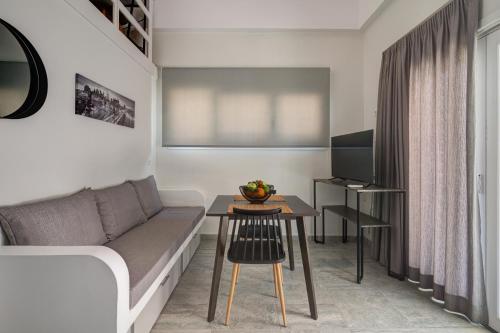 a living room with a couch and a table at Molos Beachfront Apartments in Diakopto in Diakopto
