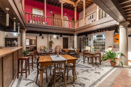 an empty restaurant with wooden tables and chairs at El Secreto del Olivo in Nigüelas