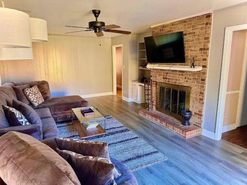 a living room with a couch and a fireplace at In the heart of the QC! in Charlotte