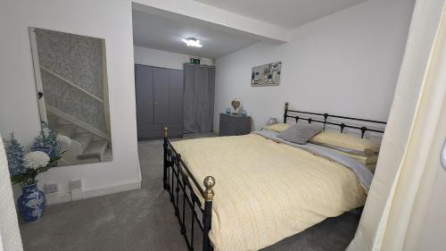 a bedroom with a large bed in a room at Spacious first floor apartment with gorgeous sea views in Weymouth