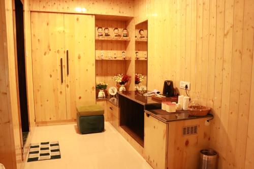 a kitchen with wooden walls and a counter in a room at Sukoon Dk in Rudraprayāg