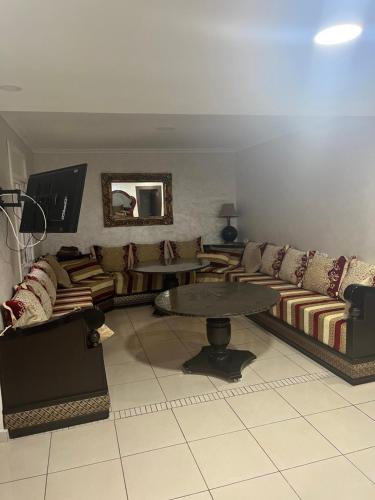 a living room with a couch and a table at Nador El jadid in Nador