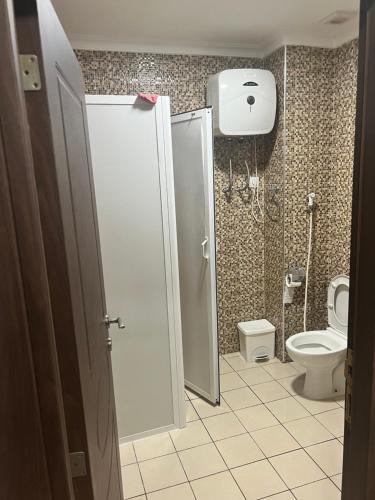 a bathroom with a toilet and a shower stall at Nador El jadid in Nador