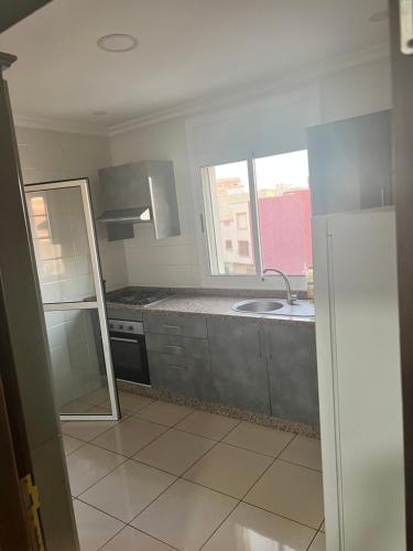 a kitchen with a sink and a window at Nador El jadid in Nador