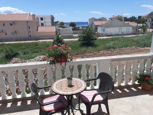 einen Tisch und Stühle auf einem Balkon mit Meerblick in der Unterkunft Ferienwohnung für 4 Personen ca 48 m in Privlaka, Dalmatien Norddalmatien in Privlaka