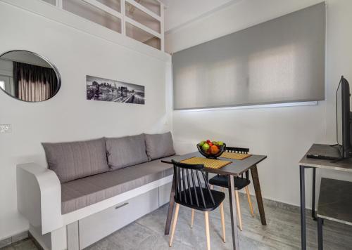 a living room with a couch and a table at Molos Beachfront Apartments in Diakopto in Diakopto
