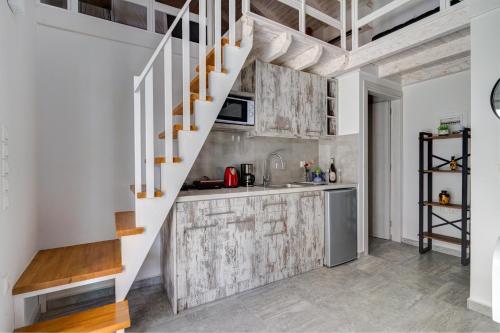 a kitchen with a staircase in a loft conversion at Molos Beachfront Apartments in Diakopto in Diakopto