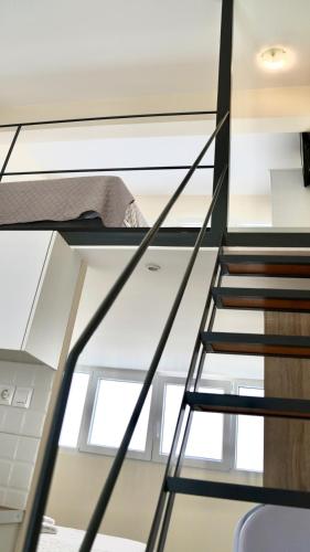 a staircase in a loft with a bed on it at Piraeus Relax in Piraeus