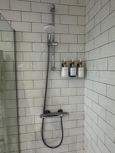 a shower with a shower head in a bathroom at The Victorian Townhouse Portrush in Portrush