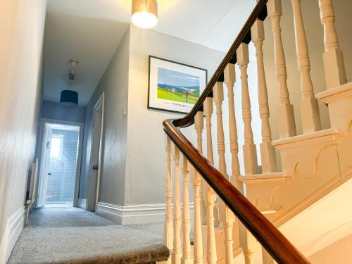 a staircase in a home with a stair case at The Victorian Townhouse Portrush in Portrush