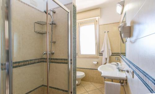 a bathroom with a shower and a sink and a toilet at Residence il Girasole 1 in Alba Adriatica