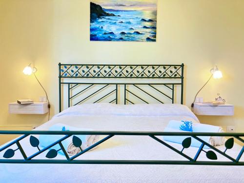 a bedroom with a bed and a painting on the wall at Beautiful apartment 100mt from the sea in Porto Torres