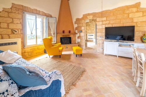 a large living room with a stone wall at Ferienhaus mit Privatpool für 7 Personen ca 120 qm in Menfi, Sizilien Provinz Agrigent in Menfi
