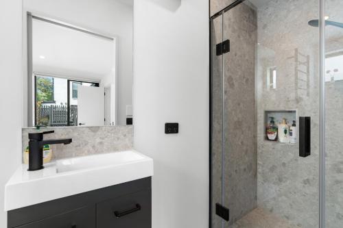 a bathroom with a sink and a shower at Brand new 3 Bed 3 Bath in Christchurch