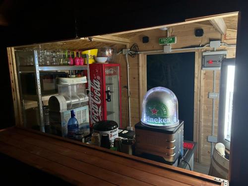 a room with a kitchen with a refrigerator and a table at Casa Bea in Palmadula