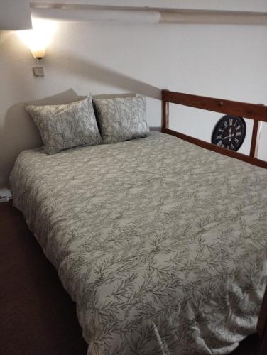 a bedroom with a large bed with a wooden headboard at Sweet Belgica in Brussels