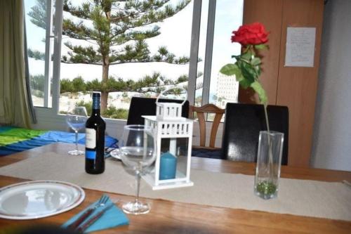 a table with a bottle of wine and glasses on it at Ferienwohnung für 6 Personen ca 85 qm in Playa de Las Américas, Teneriffa Playa de Las Américas und Los Cristianos in Playa de las Americas