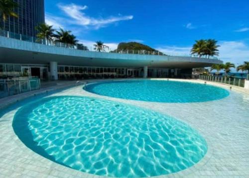 a large swimming pool in front of a building at Hotel nacional in Rio de Janeiro