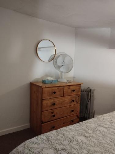 a bedroom with a dresser with a mirror on it at Sweet Belgica in Brussels