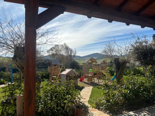 a view of a playground in a garden at Casa Bea in Palmadula