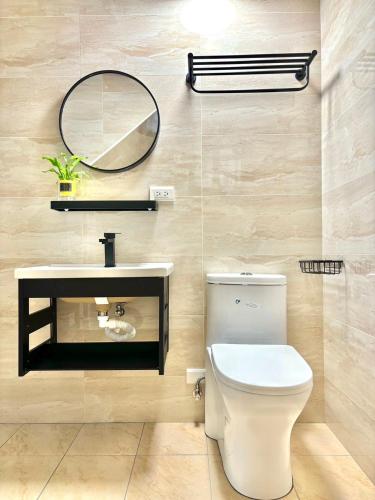 a bathroom with a toilet and a mirror at 隱 the house in Magong