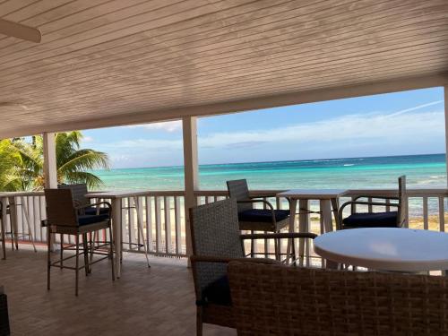 a view of the beach from a restaurant with tables and chairs at Stay BnB in Nassau
