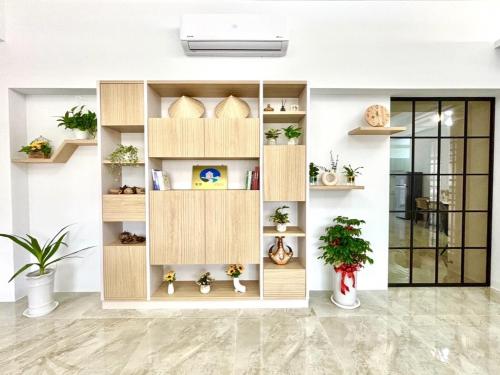 a large wooden shelf in a room with potted plants at 隱 the house in Magong