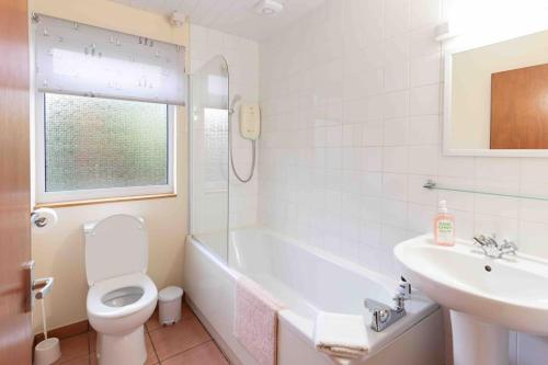 a bathroom with a toilet and a sink at Garden Cottage Helensburgh in Helensburgh