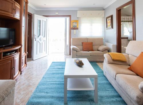 a living room with a couch and a table at AG Casa Nosa Playa Pedra do Sal a 500 metros in Lema