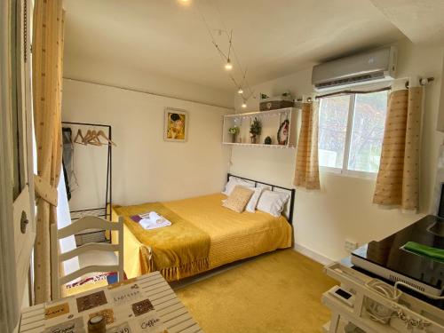 a small bedroom with a bed and a window at Ocean Garden, 4 units by the ocean in São Vicente
