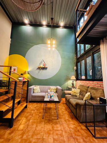 a living room with a couch and a table at Loft Industrial Morelia in Morelia