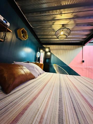 a bedroom with a large bed with a ceiling at Loft Industrial Morelia in Morelia