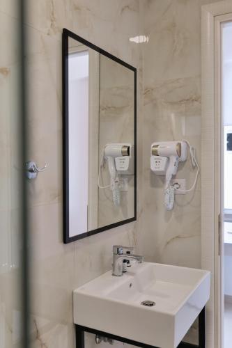 a bathroom with a sink and a mirror at Fabeno Villa in Sarandë