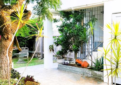 a white house with plants on the side of it at Bananaquit Near the beach! in Crown Point