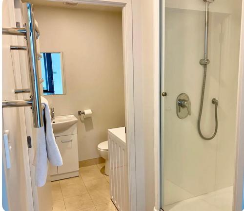 a bathroom with a shower and a toilet at Newly renovated home in Auckland city in Auckland