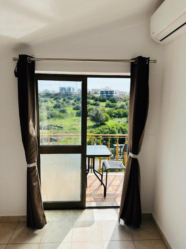 a view of a balcony with a table and a window at Portimao Central Holiday Guesthouse in Portimão