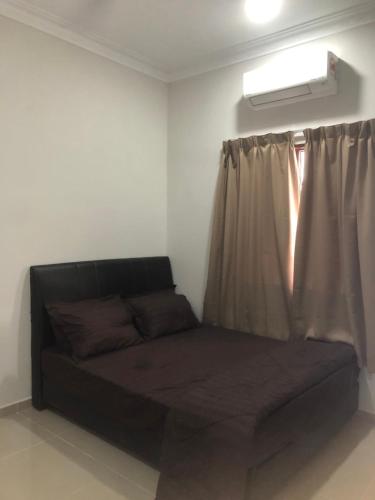 a couch in a room with a window at Homestay Siti Klang in Klang
