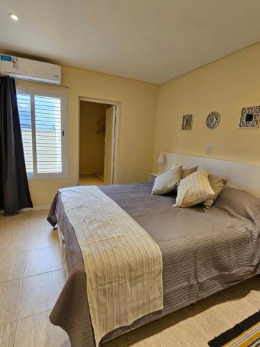 a bedroom with a large bed with two pillows at Azcuenaga Sur 2 in Guaymallen