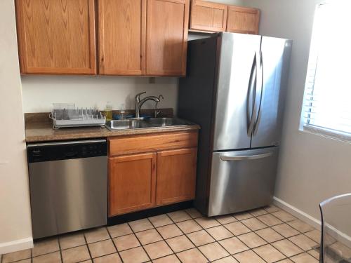 a kitchen with a stainless steel refrigerator and a sink at Apartment close to Tech Giants, fast internet in East Palo Alto