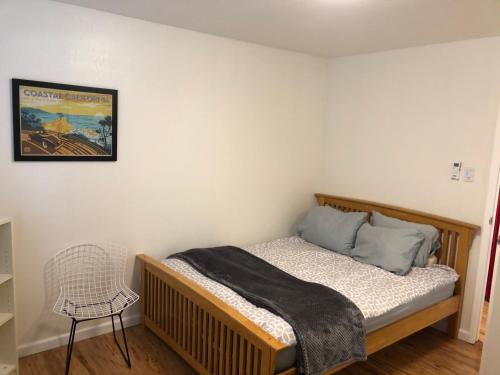 a small bedroom with a bed and a chair at Apartment close to Tech Giants, fast internet in East Palo Alto